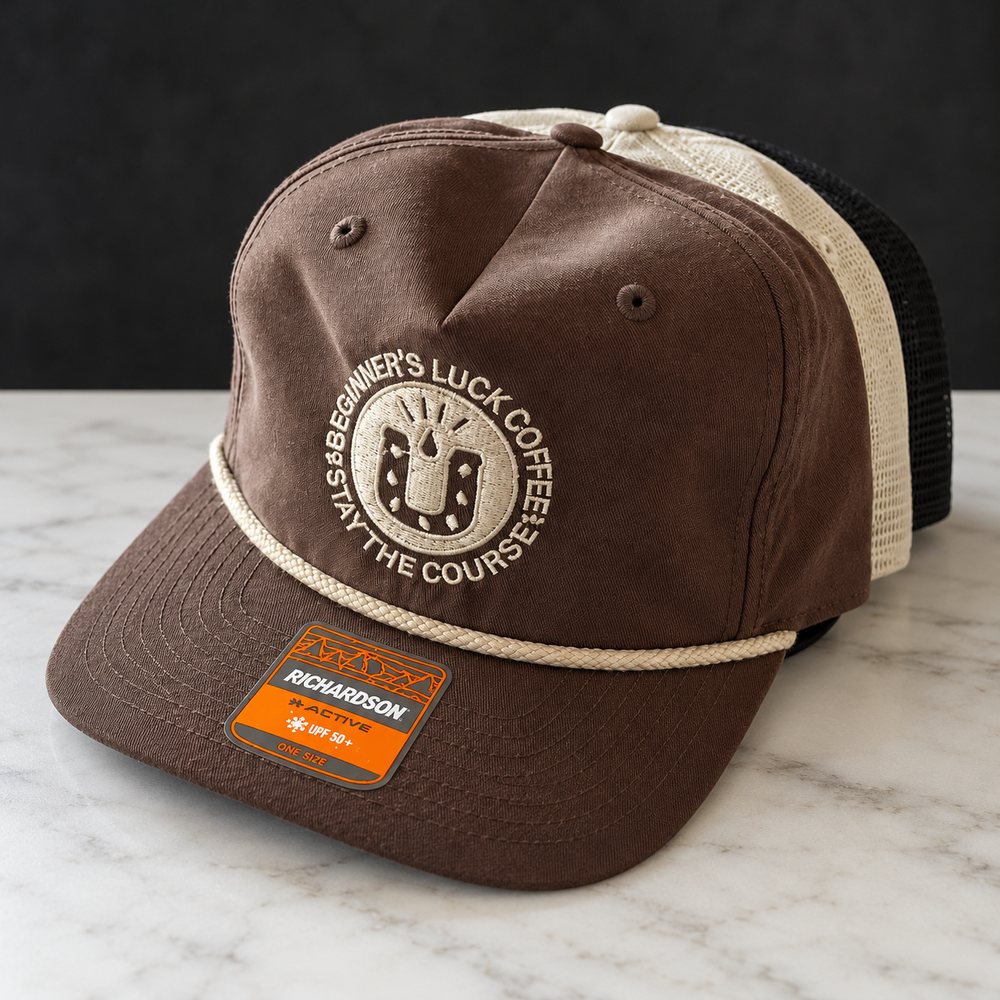 Brown and cream rope trucker hat with the embroidered horseshoe